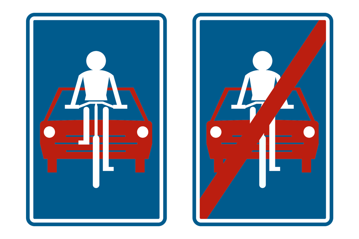Twee verkeersborden naast elkaar: het begin en het einde van een fietszone.